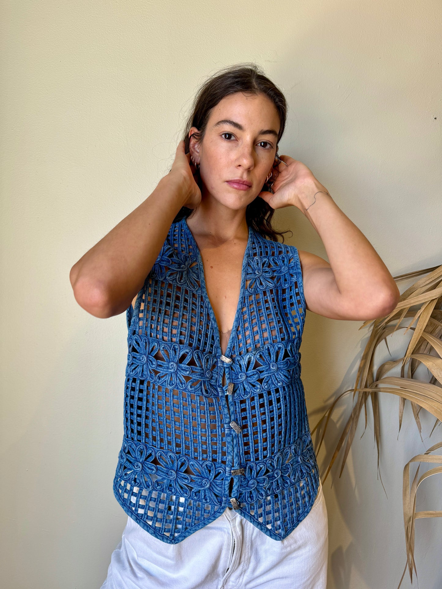 alt view of denim daisy vest on model